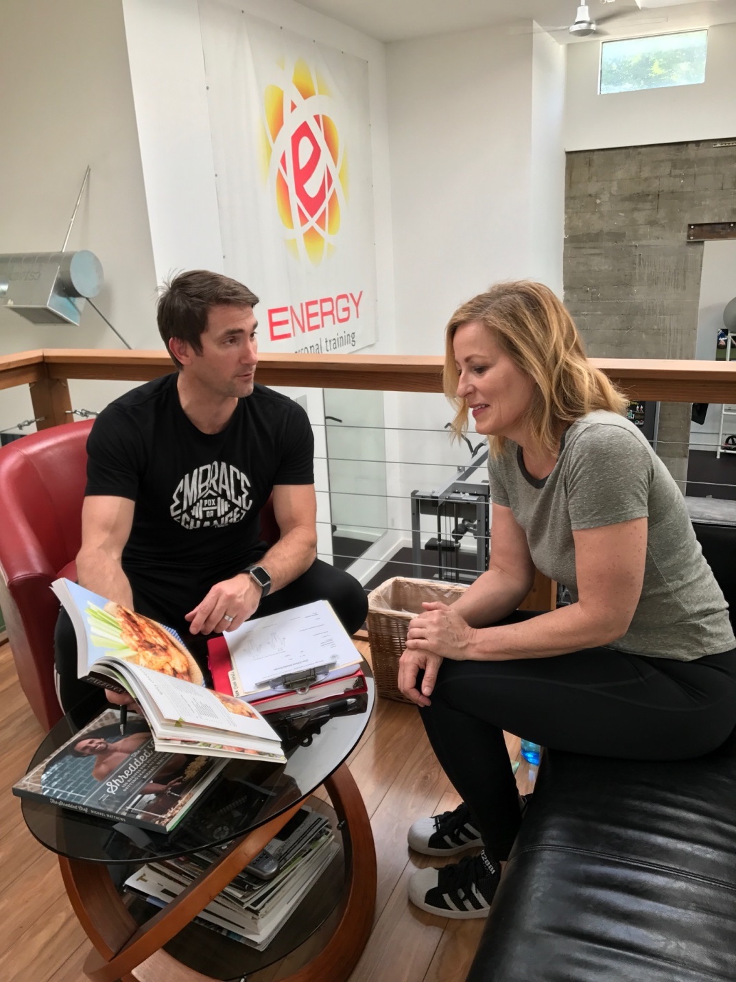 Picture of trainer sitting down with Client during a counseling session